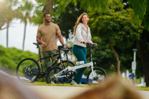 advertising photography of couple standing on bike path with collapsible bikes