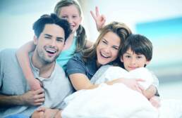 lifestyle photography of family on a bed