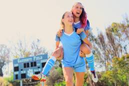 Branding Photographer - Two female soccer players celebrate.